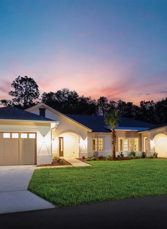 street view of brand new villa homes at Village on the Green Senior Living Community, illuminated at night