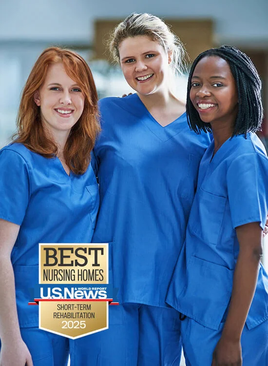 Three smiling nurses in blue uniforms beside Best Nursing Homes 2025 badge.
