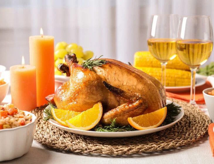 Delicious roasted turkey with garnish on dinner table