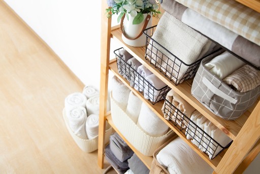 Organized linen stand with many towels 