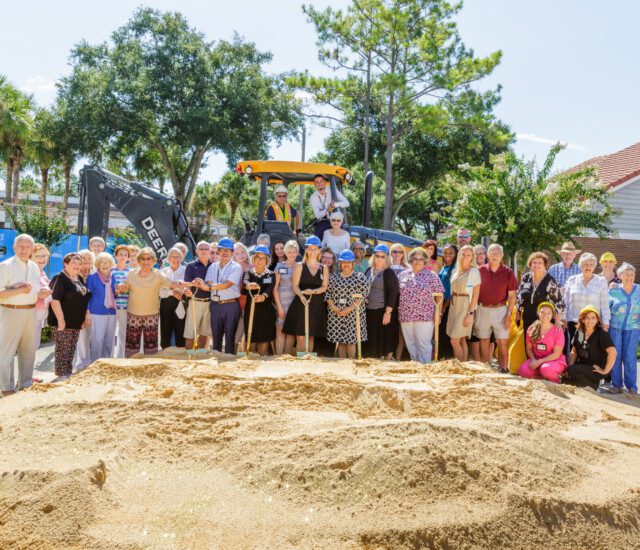 seniors and staff stand for a photo and celebrate the groundbreaking of a new project