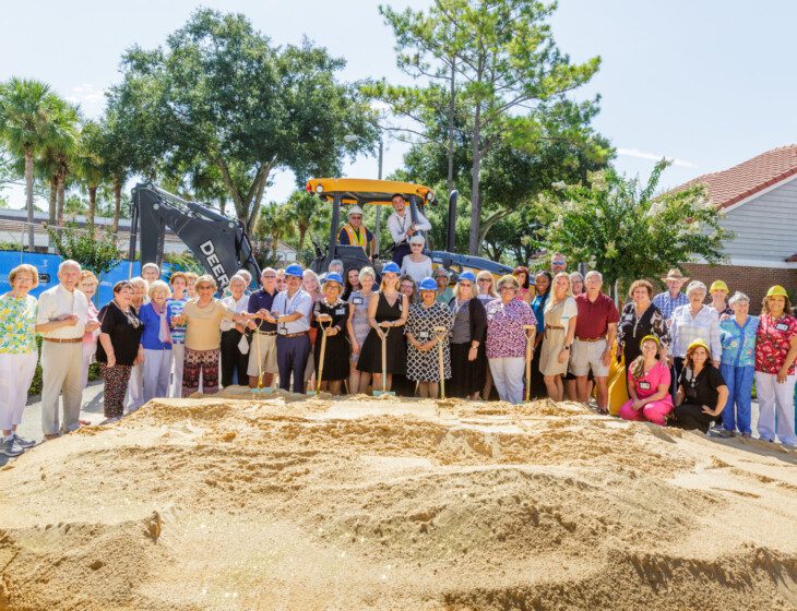 seniors and staff stand for a photo and celebrate the groundbreaking of a new project