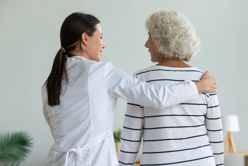 memory care resident with a caregiver in a memory care facility