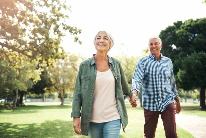 senior couple walking enjoying the outdoors and sunshine