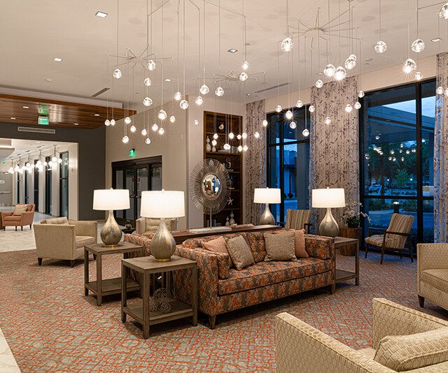 Modern and elegant waiting lounge with seating and hanging orb lights at Village on the Green