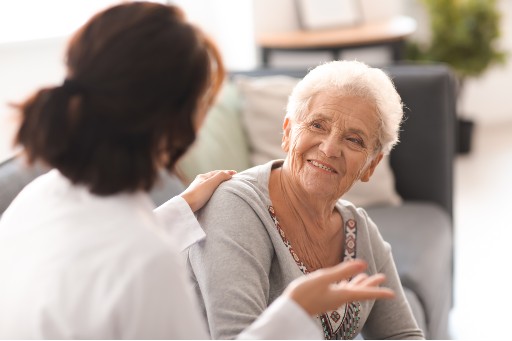 senior talking with a healthcare worker about living in assisted living