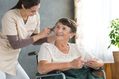 healthcare worker assisting an elderly woman in a skilled nursing home