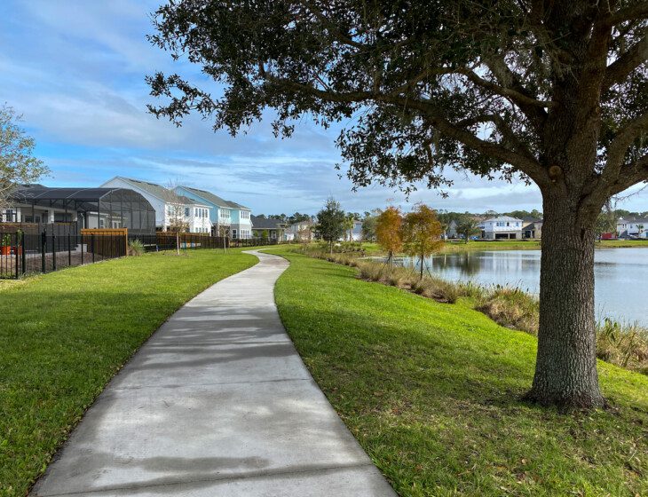 scenic waterfront walking path during the fall at Village on the Green Senior Living Community