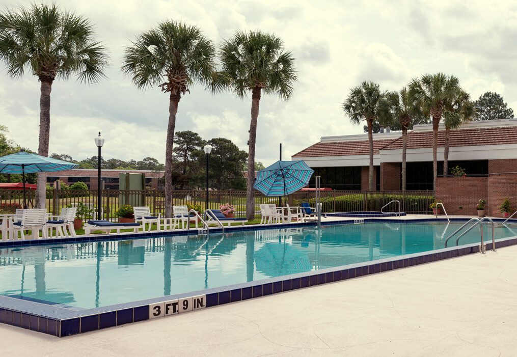 panoramic shot of resort-style outdoor swimming pool at Village on the Green senior living community