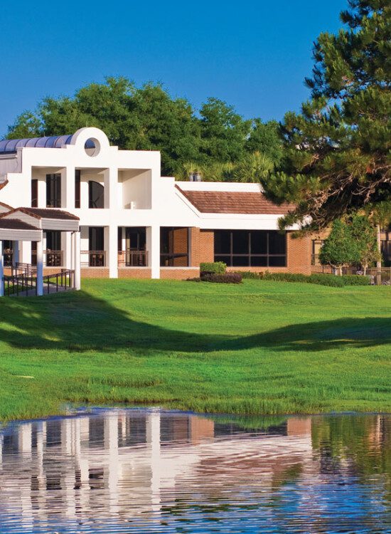 view of pond and walking path at Village on the Green Senior Living Community