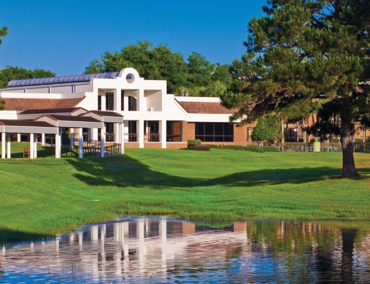 view of pond and walking path at Village on the Green Senior Living Community