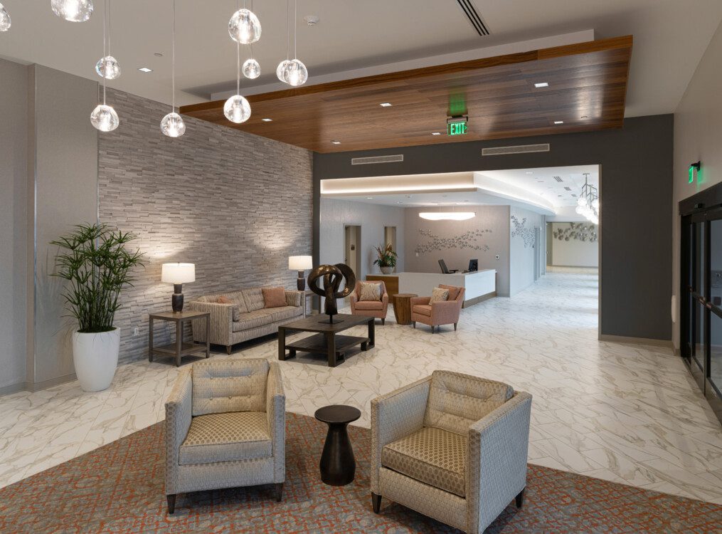 Modern and elegant waiting lounge with seating and hanging orb lights at Village on the Green
