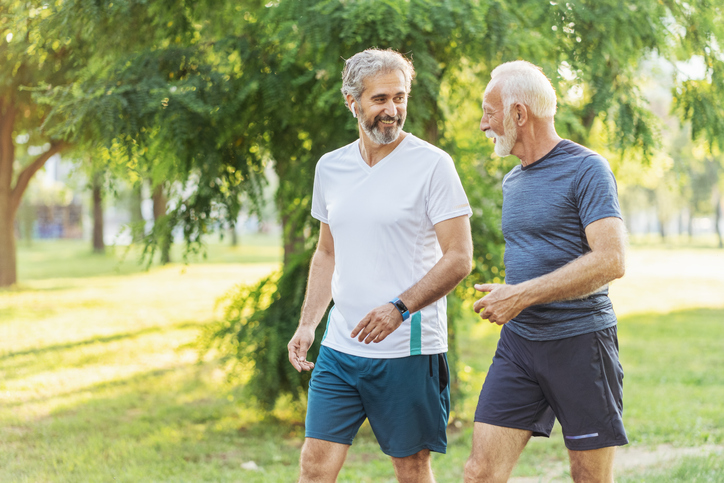 Two senior men talking and exercising together