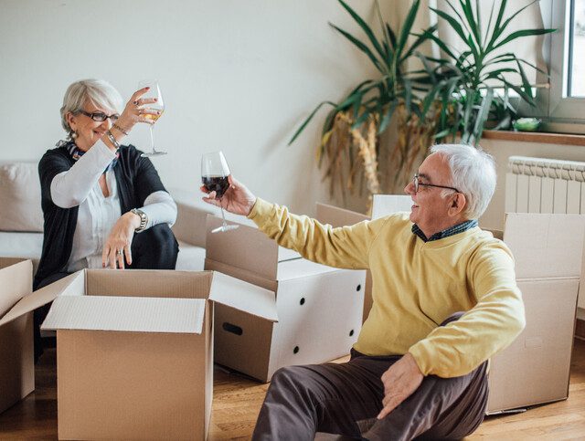 Couple making a toast as they move into their new home.