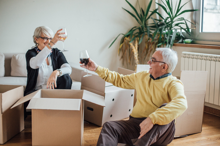 Couple making a toast as they move into their new home.